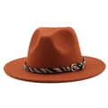 Detail of rust red wool fedora hat featuring a stylish zebra print band and metal buckle - M (56-58cm) / Caramel