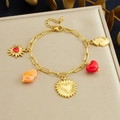 Detail of gold chain bracelet with red heart pendants and sun-shaped charms - Charm Bracelet (B1834)