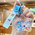 Blue star-shaped liquid keychain with bear charms and happy printed silicone strap - Fresh Star - Blue