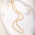 Detail of gold heart-shaped chain links with lobster clasp on ceramic tray - A0151 Heart Link Chain
