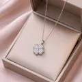 Elegant rotating silver clover necklace with shimmering zircon inlay on pink satin - X3166 Steel Heart Rotating