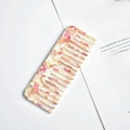 Pink and beige marble pattern acetate wide-tooth hair comb on a vintage book - Apricot Marble