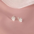 Silver bow stud earrings with white pearls on a soft pink silk background - Butterfly Bow Artificial Pearl Style (A180)