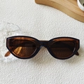 Retro Y2K cat-eye sunglasses with translucent dark blue frames and amber lenses - Transparent Dark Tea