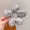 Close-up of a metallic silver oversized flower hair tie with 3D sponge padding - Shiny Silver (Approx. 10.5cm)