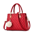 Detail of red quilted women's handbag with gold hardware and white faux fur keychain - Red