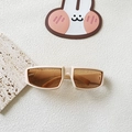 Detail view of cream rectangle Y2K sports sunglasses with orange lenses on a textured stone base - Off White Champagne