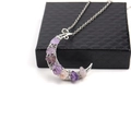 Detailed shot of silver crescent moon pendant with purple crushed crystal on a black gift box - Purple Crystal