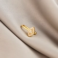 Macro view of gold-tone evil eye nose cuff with cubic zirconia on soft silk fabric - Evil Eye (E5689-20)