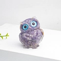 Cute purple crystal resin owl statue with golden spots on a clean white display base - Lilac Stone