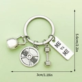 Detail of metal gym keychain featuring kettlebell, barbell weight, and dumbbell charms - LS182-ME VS ME