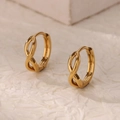Gold infinity hoop earrings with polished finish and secure clasp on textured paper - Gold Infinity