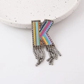 Detailed view of colorful beaded letter K brooch with crystal fringe and rhinestone border - Letter K
