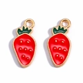 Detailed view of two strawberry alloy pendants with red enamel and gold leaf accents - Radish Strawberry
