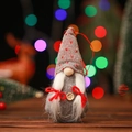 Detail of a Christmas gnome ornament with a heart-patterned knitted hat and wood button - Grey Heart Braid Hat Style