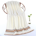 Thick cream cotton bath towel with brown stripes draped over a rattan chair - Striped Border Hand Towel (Cream White) / 34*74cm