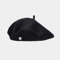 Detail of wool beret showing the smooth felt texture and silver metallic logo engraving - Black