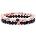Close-up of 6mm distance bracelets with orange-white textured and matte black beads - Red Network Stone