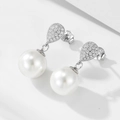 Macro detail of S925 sterling silver stamp on water drop pearl earrings with cubic zirconia - 925 Silver / Silver
