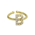 Detail of 18k gold plated adjustable ring featuring letter B set with white pearls - Letter B / Gold