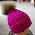 Women's rose pink knitted beanie hat with a large brown fluffy faux fur pom-pom detail - Rose Red
