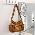 Vintage brown canvas crossbody bag with adjustable strap and dual buckle closures - Brown