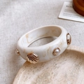 Detail of a wide resin bangle with marble texture, golden shells, and faux pearls - 15# Bangle-Cream White-Shell