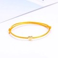 Adjustable yellow braided cord bracelet with a small golden heart pendant - Yellow/Gold
