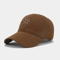 Detailed view of white sun embroidery on brown cotton twill baseball cap with curved brim - Coffee