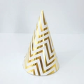 Classic cone birthday party hat with golden zigzag patterns on white paper surface - One Size / Gold Waves