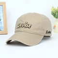 Khaki cotton baseball cap with embroidered letters in a minimalist lifestyle setting - Adjustable / Khaki