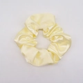 Pale yellow satin scrunchie with smooth silk texture and natural pleats on white background - Light Yellow