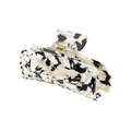 Macro shot of 8.2cm rectangular acetate hair claw with marble pattern and gold spring - Black and White Marble