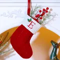 Classic red knitted Christmas stocking with white embroidered letter E and holly motif - Letter E / Red