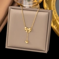 Elegant gold bow and heart pendant necklace displayed on a luxury jewelry box - [XLH158] Heart Bow Pendant Necklace Gold