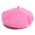 Detailed texture of a bright pink wool beret with a small classic tail on top - Pink