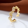 Detailed macro shot of a gold butterfly ring with sparkling pink inlaid gemstones - Adjustable Open / Gold Color Pink Zirconia