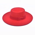 Close-up of bright red wool boater hat featuring a flat top and matching ribbon bow - Red