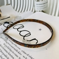 Detail of tortoise shell acetate headband placed on an open magazine for a retro look - Porcelain Blue Tortoiseshell - Glasses Shape