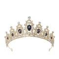 Macro detail of luxury golden crown featuring purple waterdrop gems and white crystals - Gold / Deep Purple Gemstone