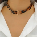 Detail shot of a leopard print choker with a gold heart-shaped metal pendant - Leopard Print Heart Metal Buckle Style (X320)