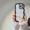 Detail of black wavy edge silicone case for iPhone 16 with aesthetic rainbow light shadow - Black