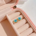 Evil eye stud earrings with gold rim and blue eye pattern in a pink jewelry gift box - Gold