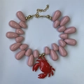 Detailed view of ocean style pink teardrop beads and red crab pendant necklace - Pink Crab