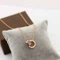Rose gold double ring necklace with Roman numerals and cubic zirconia on velvet - Roman Numeral Necklace