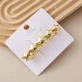 Elegante fermaglio per capelli con stelle dorate a cinque punte su cartoncino bianco - Oro a Catena di Stelle Lucido