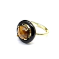 Detail of faceted brown gemstone ring with a black halo on a gold metal band - Tiger's Eye