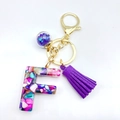 Letter F resin keychain with multicolor stone filling and a purple suede tassel - Letter F
