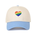 Close-up detail of a vibrant rainbow heart embroidery on a stylish two-tone baseball cap - Light Blue