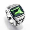 Macro shot of silver stainless steel ring featuring a green square gemstone and vintage relief - Steel Color Olive Green Gemstone